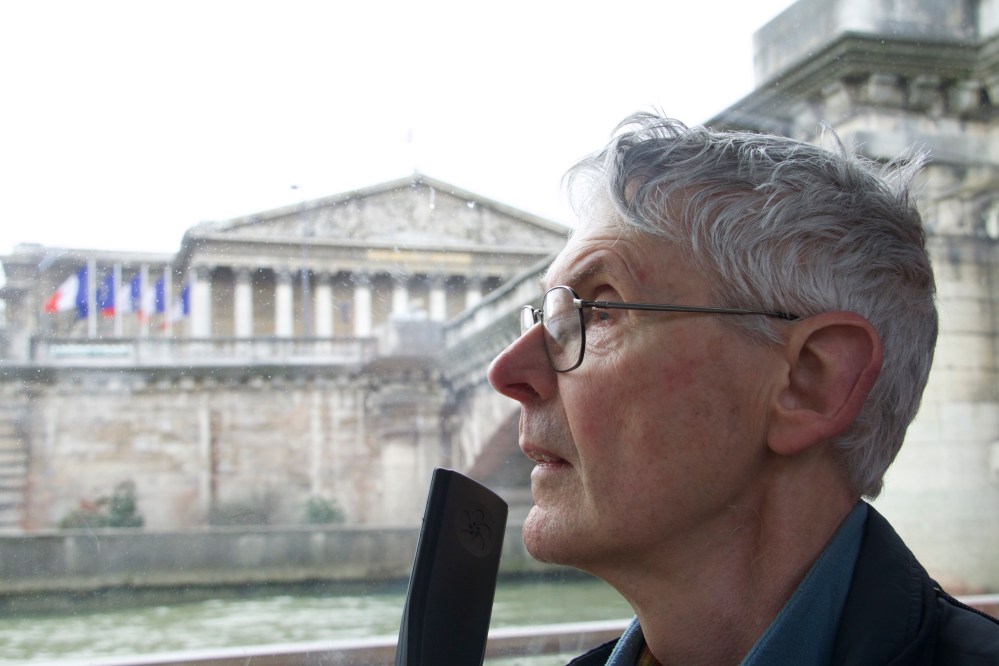 Chris listens to the commentary as he passes the Assemblee Nationale